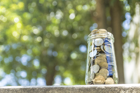 Concept of saving money by collecting coins in a glass jar. Money Thailand.の写真素材