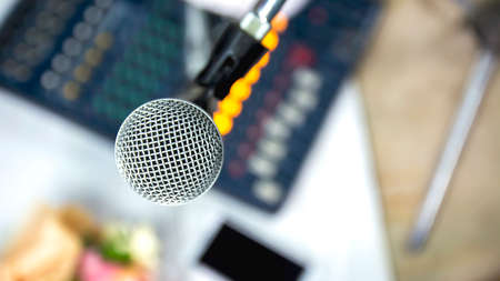 Microphone on stand with backdrop of recording device.の写真素材