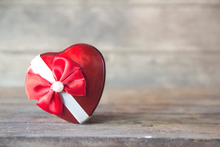 Heart shape gift box on wooden table.の写真素材