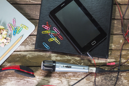 Microphone, headphones, a diary on a wooden table.の写真素材