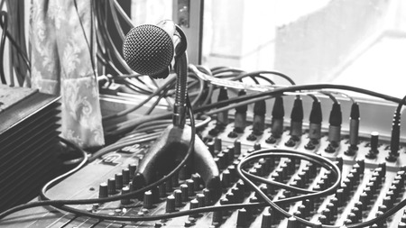 Microphone on a stand with audio mixer in the control room audio system.の写真素材