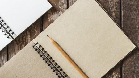 Diary brown with pencil on wooden desk.の写真素材
