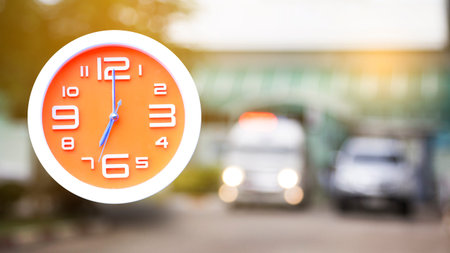 Orange wall clock, time concept with rescuers.