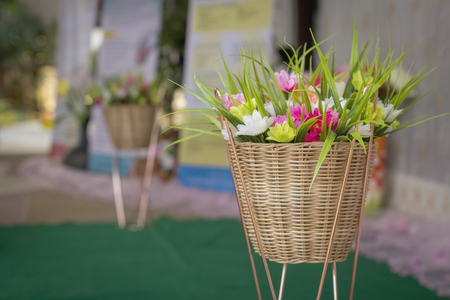 Artificial flower in wooden basket.の写真素材