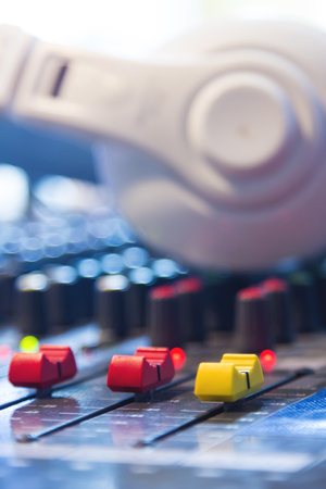 Slide the button to adjust the volume mixer of audio professionals. In the studio recording.の写真素材