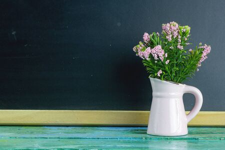 Vintage artificial flowers in a vase.の写真素材