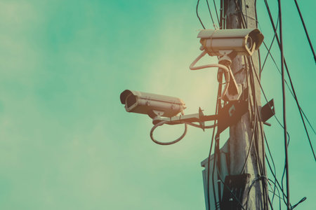 CCTV cameras installed on electrical poles.の写真素材