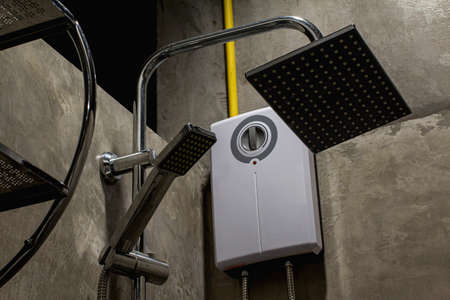 Shower in the shower and cement loft wall.の写真素材