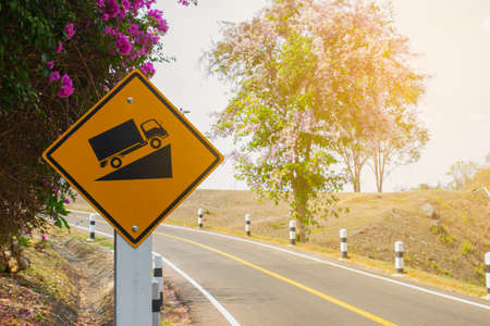 Traffic warning signs, the car is going up a steep slope.の写真素材