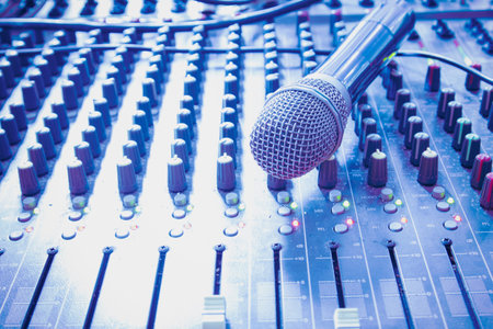 Wireless microphone in the control room, cool color tones. Online conference / study equipment.