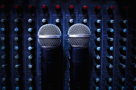 Top View Two wireless microphone transmits radio waves on a professional audio mixer in a conference...
