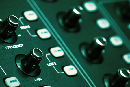 The volume control knob of a digital audio mixer in a conference room control room.の写真素材
