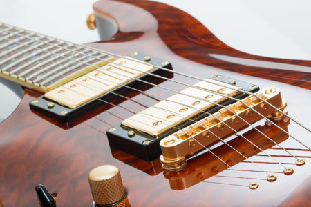Electric guitar with gold pickups and saddle.