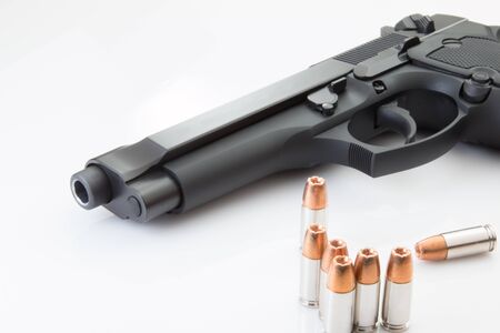 Handgun pistol with ammunition bullets on white background.の写真素材