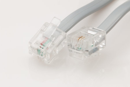 Telephone cable connectors on white background.