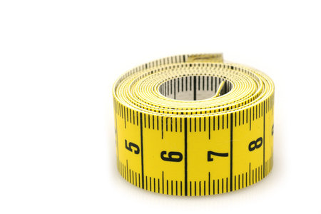 curled up tape measure on a white background 