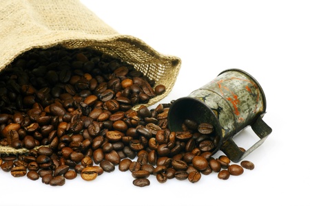 measuring cup and a burlap bag with coffee beans on a white background の写真素材