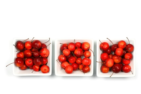fruits of the Malus Pumila (crab apple) in white bowls on a white background の写真素材