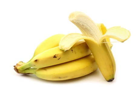 a bunch of bananas and one peeled on a white background の写真素材