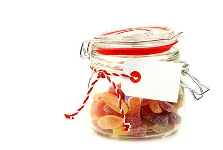glass jar with colorful candy with room for your text or images on a white background の写真素材