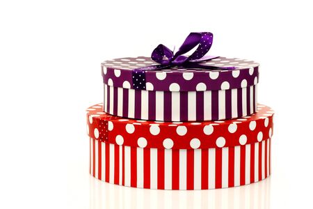 red and purple striped gift boxes on a white background の写真素材