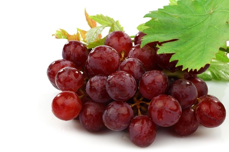 red and white grapes and some foliage on a white background の写真素材