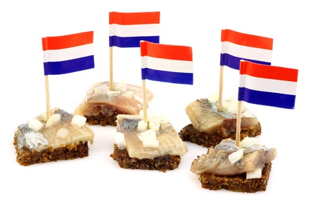 Fresh herring  Dutch  Hollandse Nieuwe   with chopped onions on rye bread on a white background の写真素材