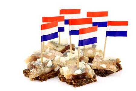 Fresh herring  Dutch  Hollandse Nieuwe   with chopped onions on rye bread on a white background の写真素材