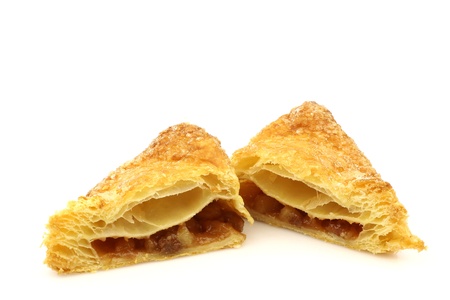 freshly baked crispy apple turnover halves on a white background の写真素材