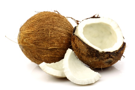 two fresh coconuts and one opened on a white background の写真素材