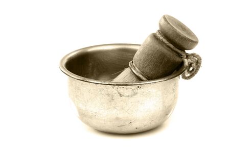 vintage shaving brush in a metal shaving bowl on a white background の写真素材