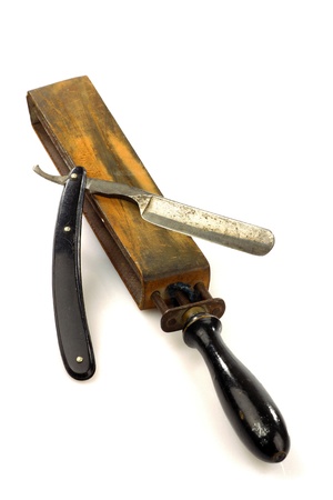 sharpening leather and an old razor isolated on a white background の写真素材