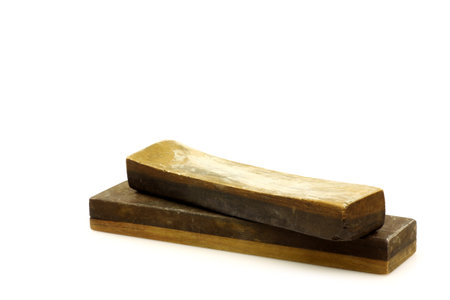 old sharpening stone on a white background 