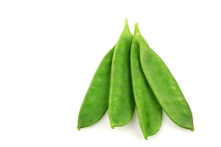 green pea pods on a white background の写真素材