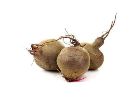 three freshly harvested beetroots on a white background 