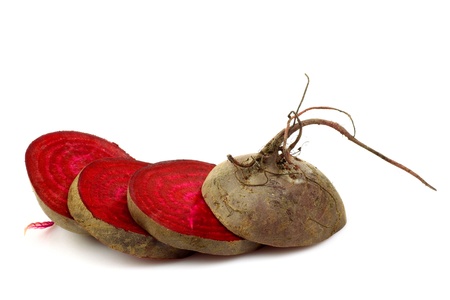 freshly cut slices of beetroots on a white background の写真素材