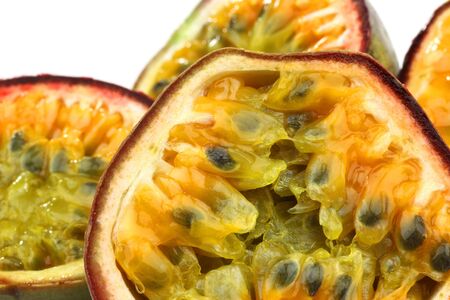 four passion fruit halves on a white background の写真素材