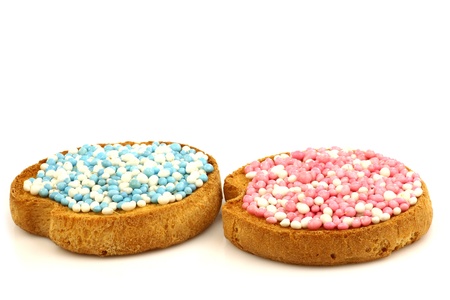 rusks with white and blue and white and pink anise seed sprinkles served in Holland when a baby boy or girl is born on a white background の写真素材