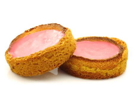 Traditional Dutch pink glazed cakes on a white background の写真素材