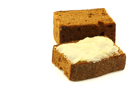 Traditional Dutch buttered breakfast cake called ontbijtkoek  on a white background