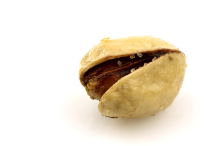 freshly roasted pistachio nut on a white background 