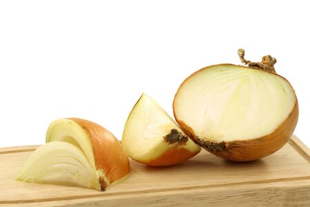 one cut fresh onion on a cutting board on a white background の写真素材