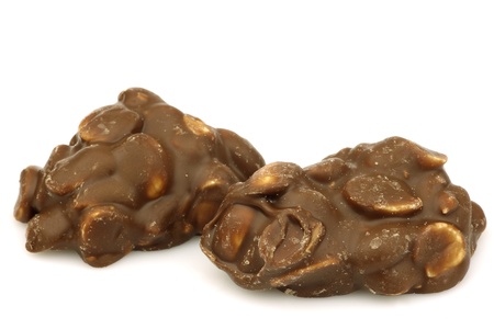 Blocks of chocolate covered peanuts on a white backgroundの写真素材