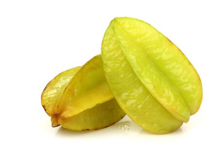 two whole carambola s  Averrhoa carambola  on a white background の写真素材