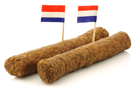 Two Dutch snacks called  fricandel  with Dutch flag toothpicks and some cut pieces on a white background の写真素材