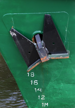 green bow of a ship with a black anchor の写真素材