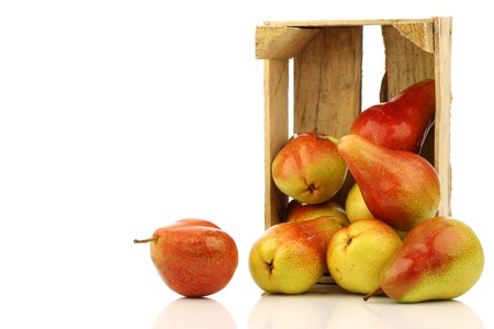 fresh and colorful  Forelle  pears in a wooden crate on a white background の写真素材
