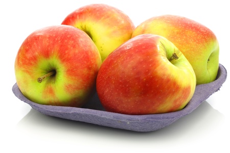 fresh new apple cultivar called  Pink Lady  on a tray on a white background の写真素材