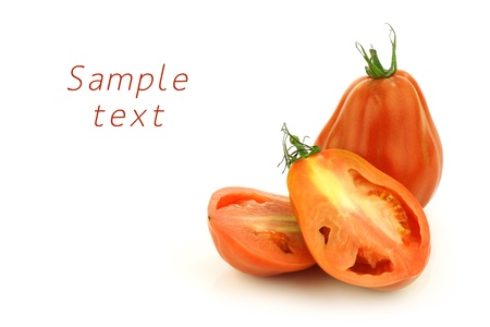 fresh beef tomato and a cut one on a white background の写真素材
