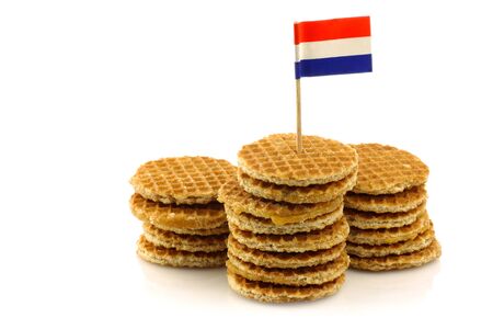 traditional Dutch mini waffles called  stroopwafels  with a Dutch flag toothpick on a white background の写真素材